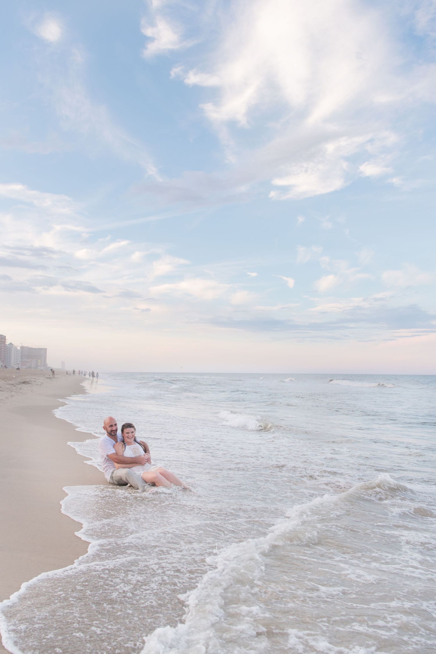 Couple on the shore of Virginia Beach. Pretty sky over Virginia Beach after a storm.