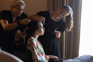 Wedding preparation scene with styling details captured in warm indoor lighting.