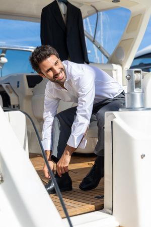 Professional adjusting equipment on a luxury yacht deck with teak flooring and bright blue sky overhead.
