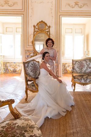 Elegant bridal portraits in a luxurious room with French baroque furnishings and gold details.