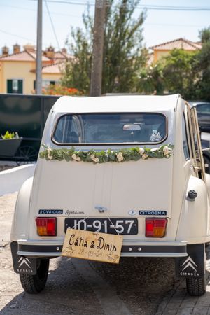 Classic white Citroen wedding car decorated with flowers and a 'Just Married' sign.
