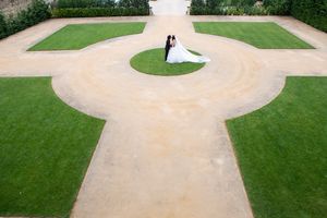Aerial view of a circular concrete pathway surrounded by manicured green lawns.