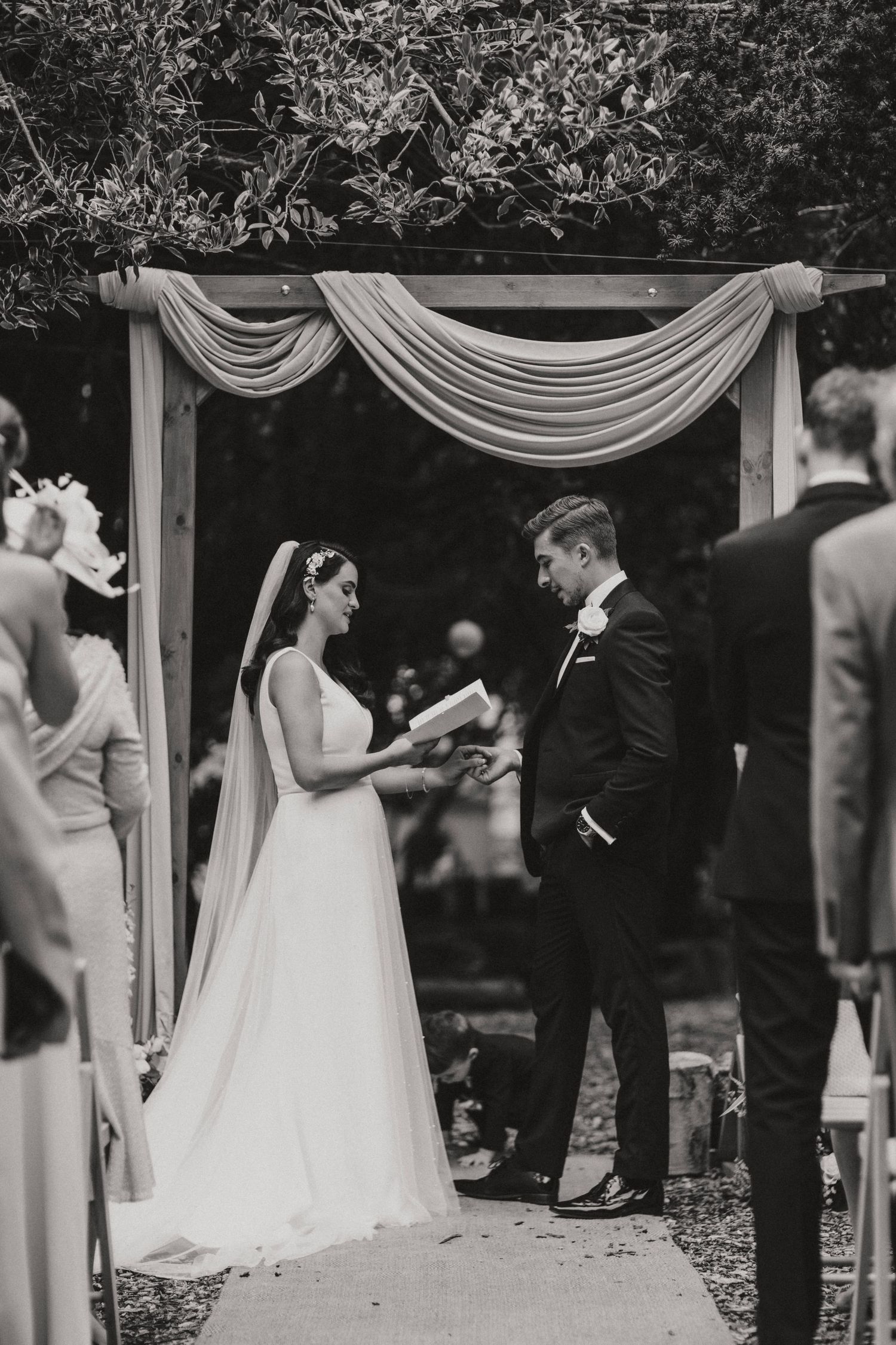 Tender moments between a bride and groom during an outdoor wedding ceremony at Hirst Priory. Taken by Grimsby photographers.