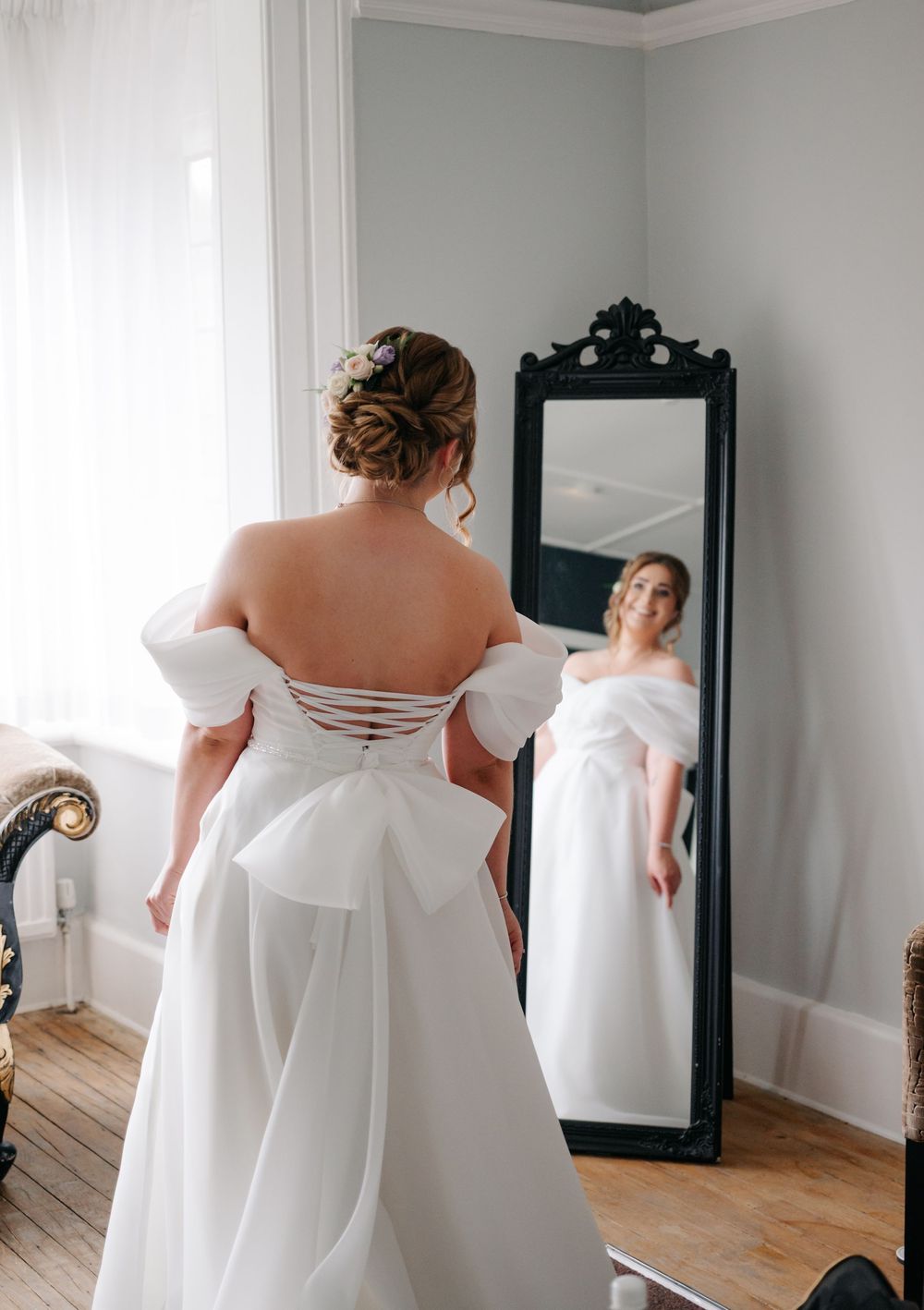 A series of elegant white wedding dress shots showing lace-up back detail and flowing fabric in natural light.