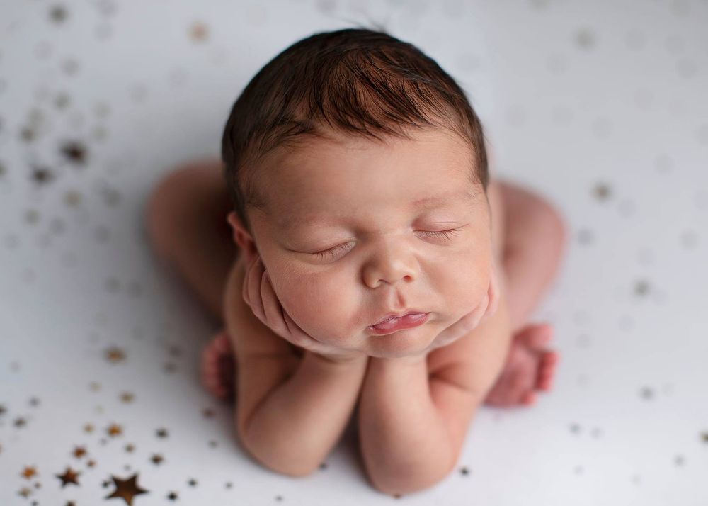 Newborn baby girl froggy pose from Elizabeth Lang Photography in Surrey.