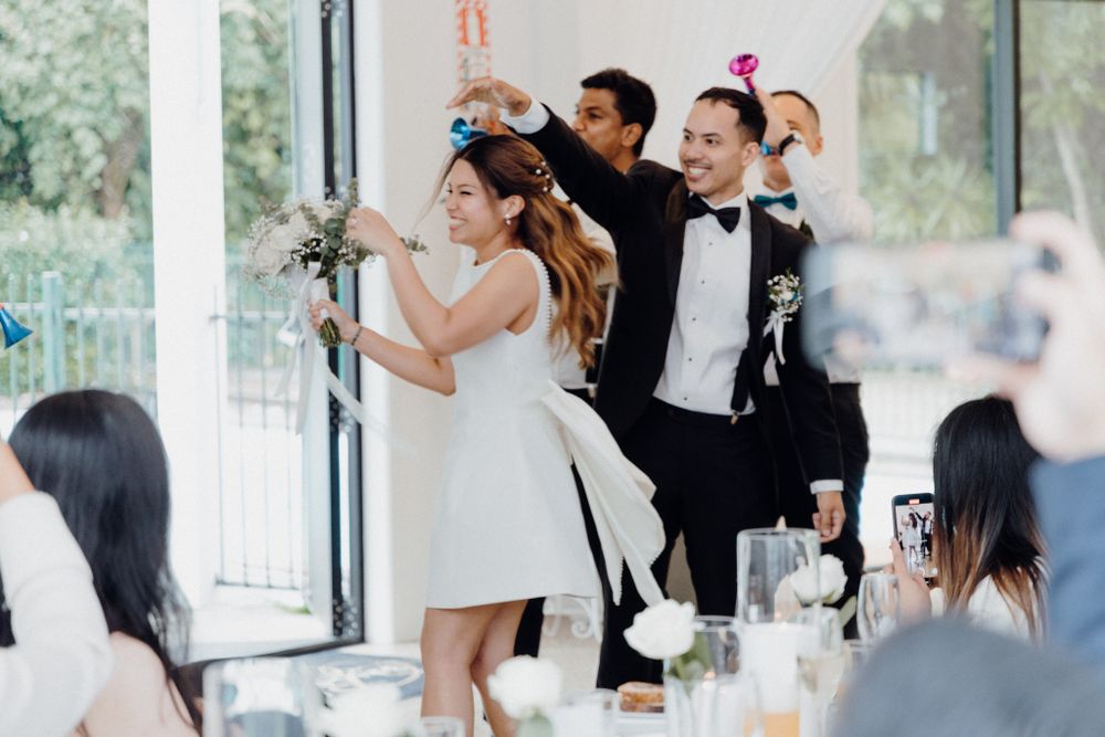 Wedding celebration at a bright reception venue captured by Apertured Media Auckland Wedding Photographer.