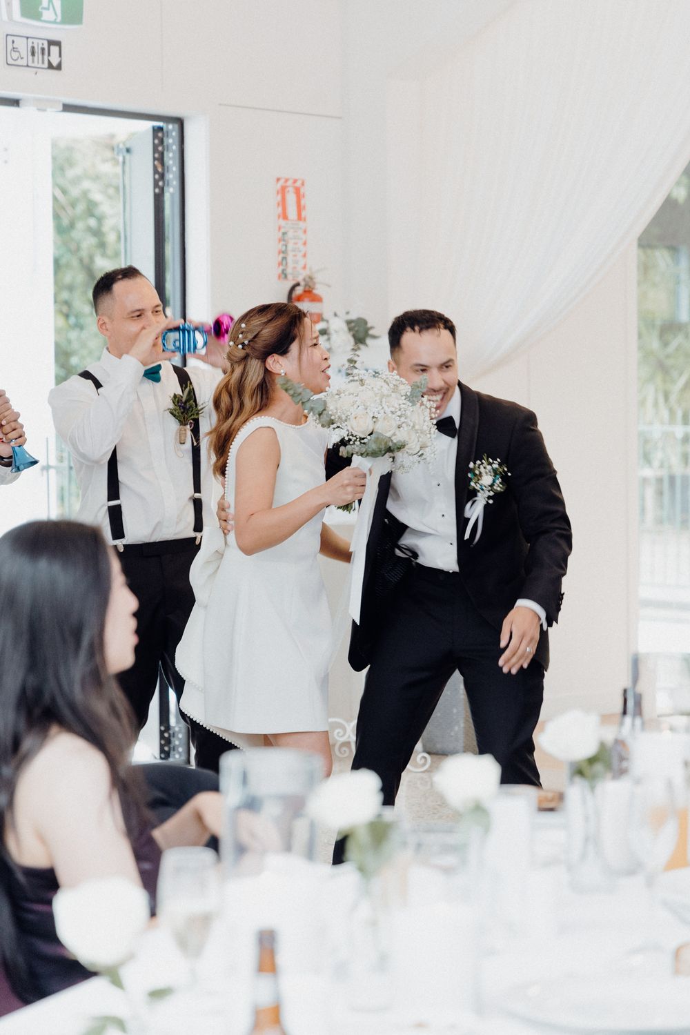 Wedding celebration at an elegant venue with people dancing at a reception captured by Apertured Media Auckland Wedding Photographer.