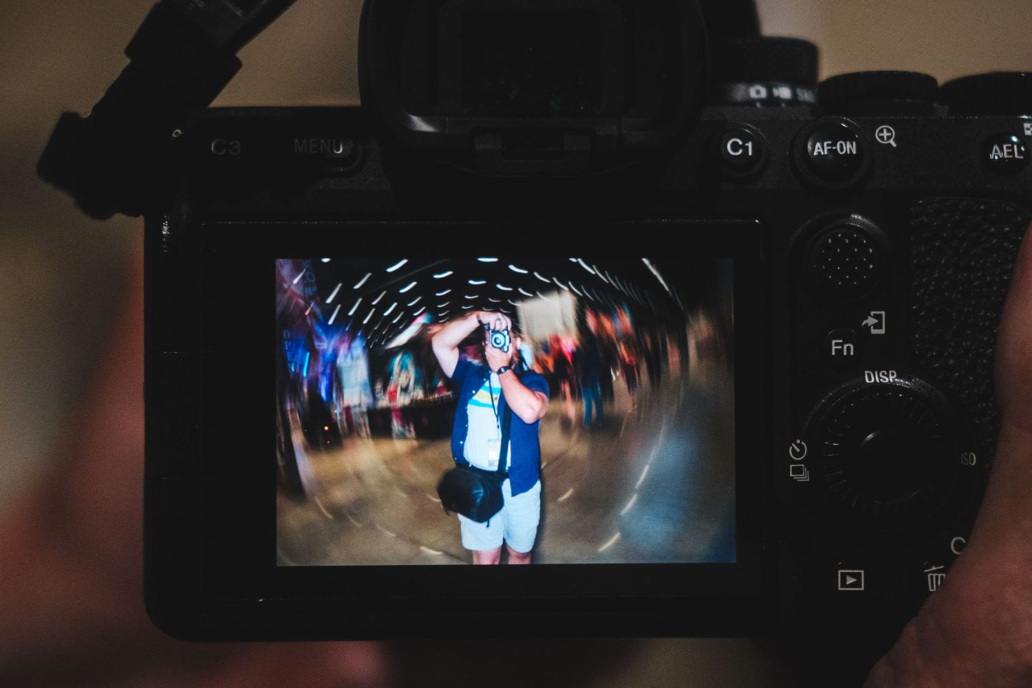 A camera LCD screen displays a motion-blurred performance shot with dynamic circular lighting effects.