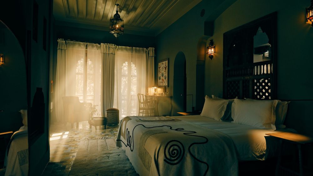 A luxurious bedroom with sunlight streaming through sheer curtains, featuring blue-green walls and ambient lighting.