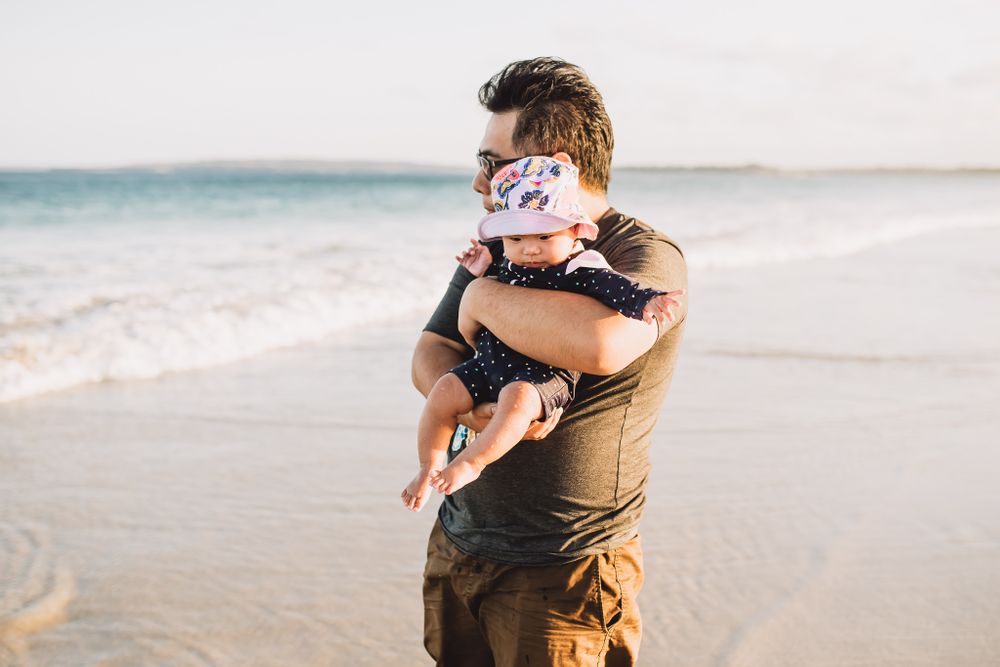 father and daughter sharing a moment at the beach