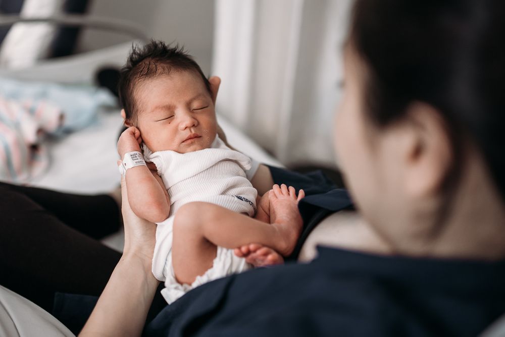 newborn baby in mother's arms