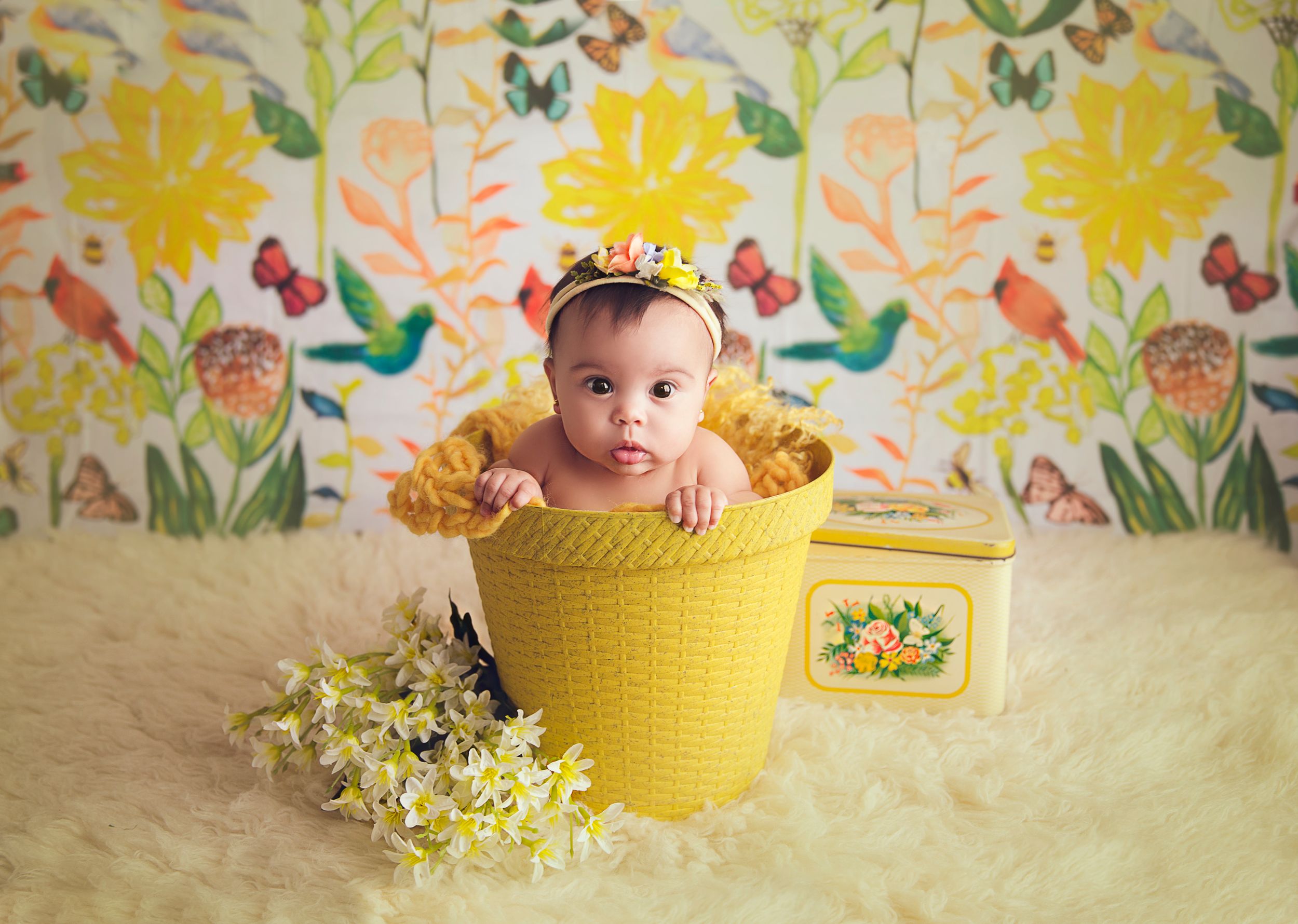 baby girl in a yellow bucket floral backdrop