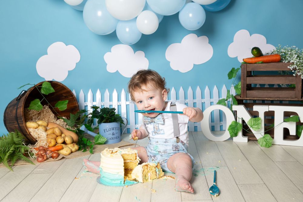 peter rabbit themed background with a child eating cake from a spoon