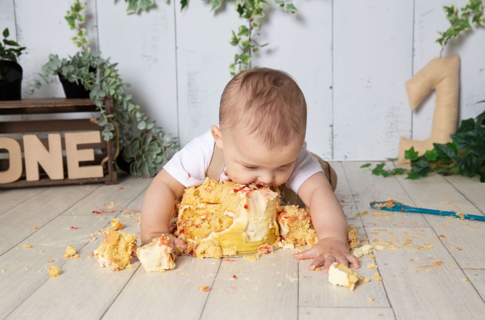 little boy eating cake face first