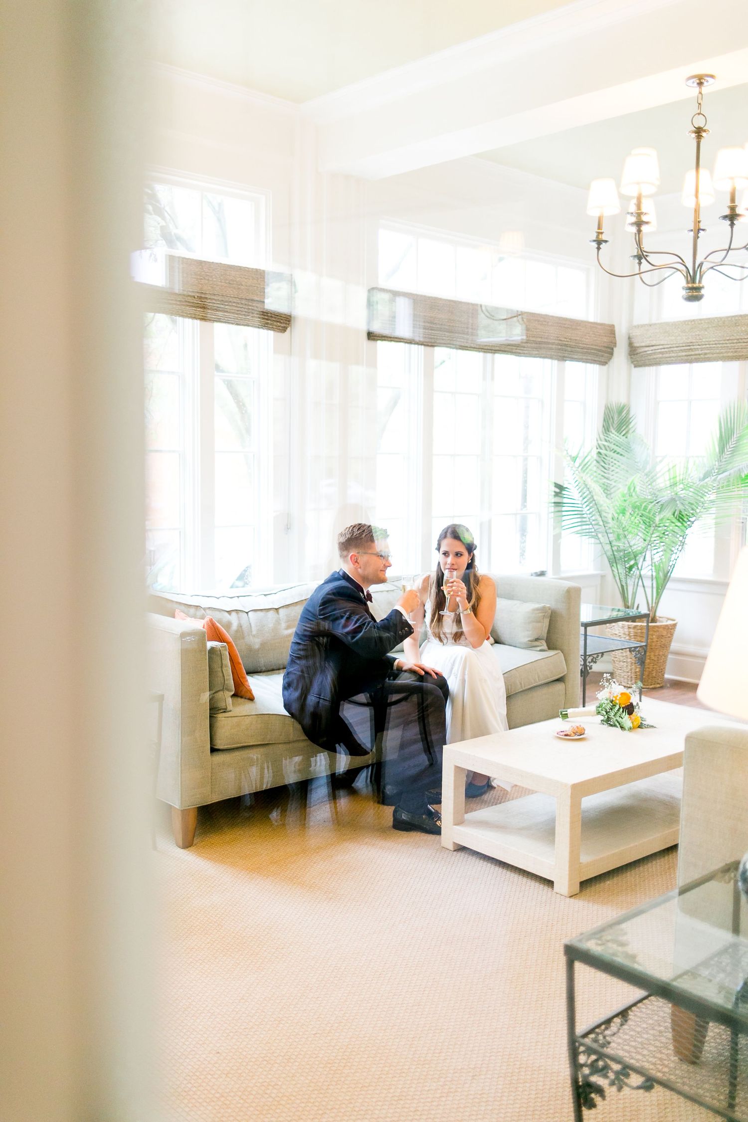 bride and groom sipping champagne in the sunroom at Woman's Club of Evanston Chicago