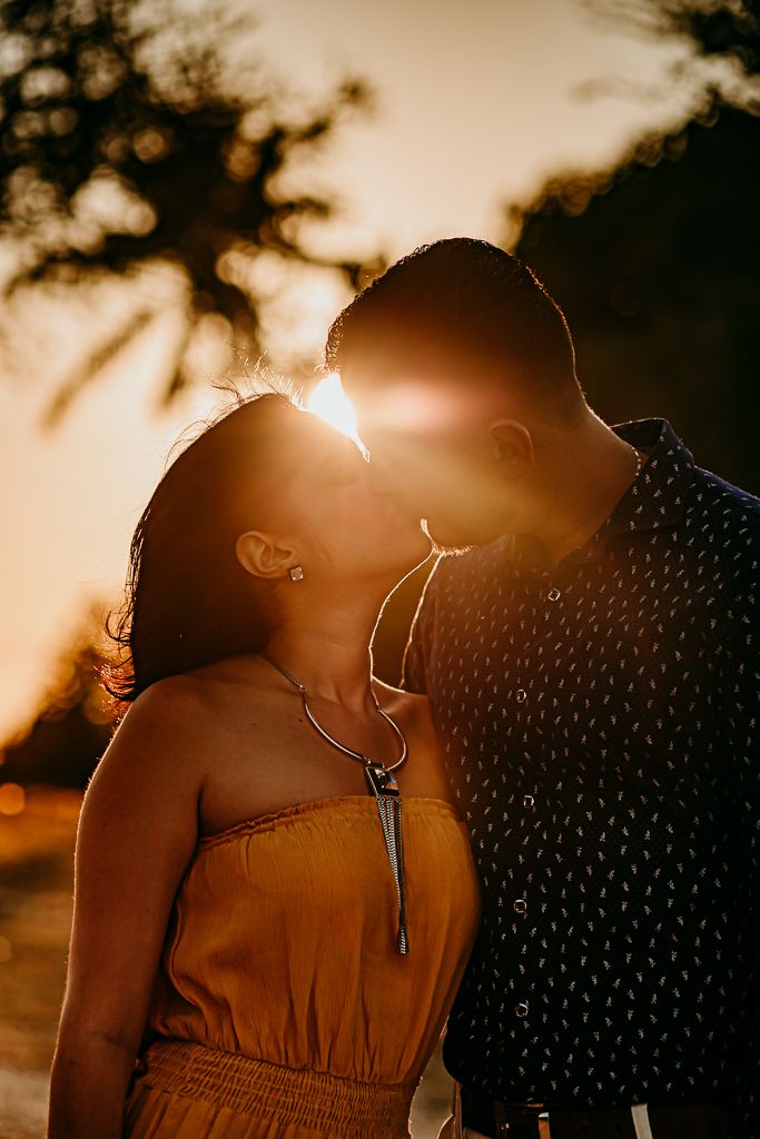 the sun illuminating a couple kissing