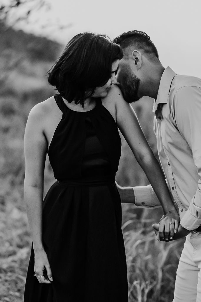 Boyfriend kissing his girlfriend's shoulder