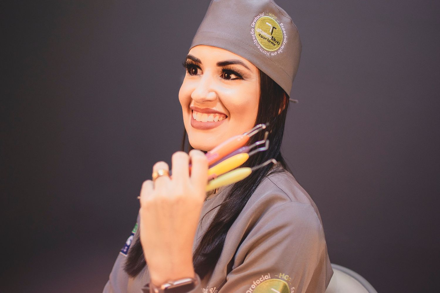Portrait of someone wearing a gray military-style uniform and hat in a studio setting.