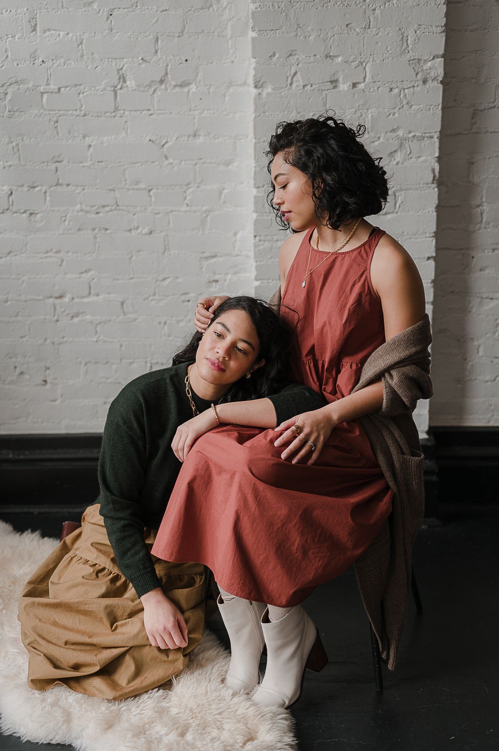 Clothing campaign brand portrait by Tiffany Kelterer of 2 women sitting together in Pioneer Square studio Seattle