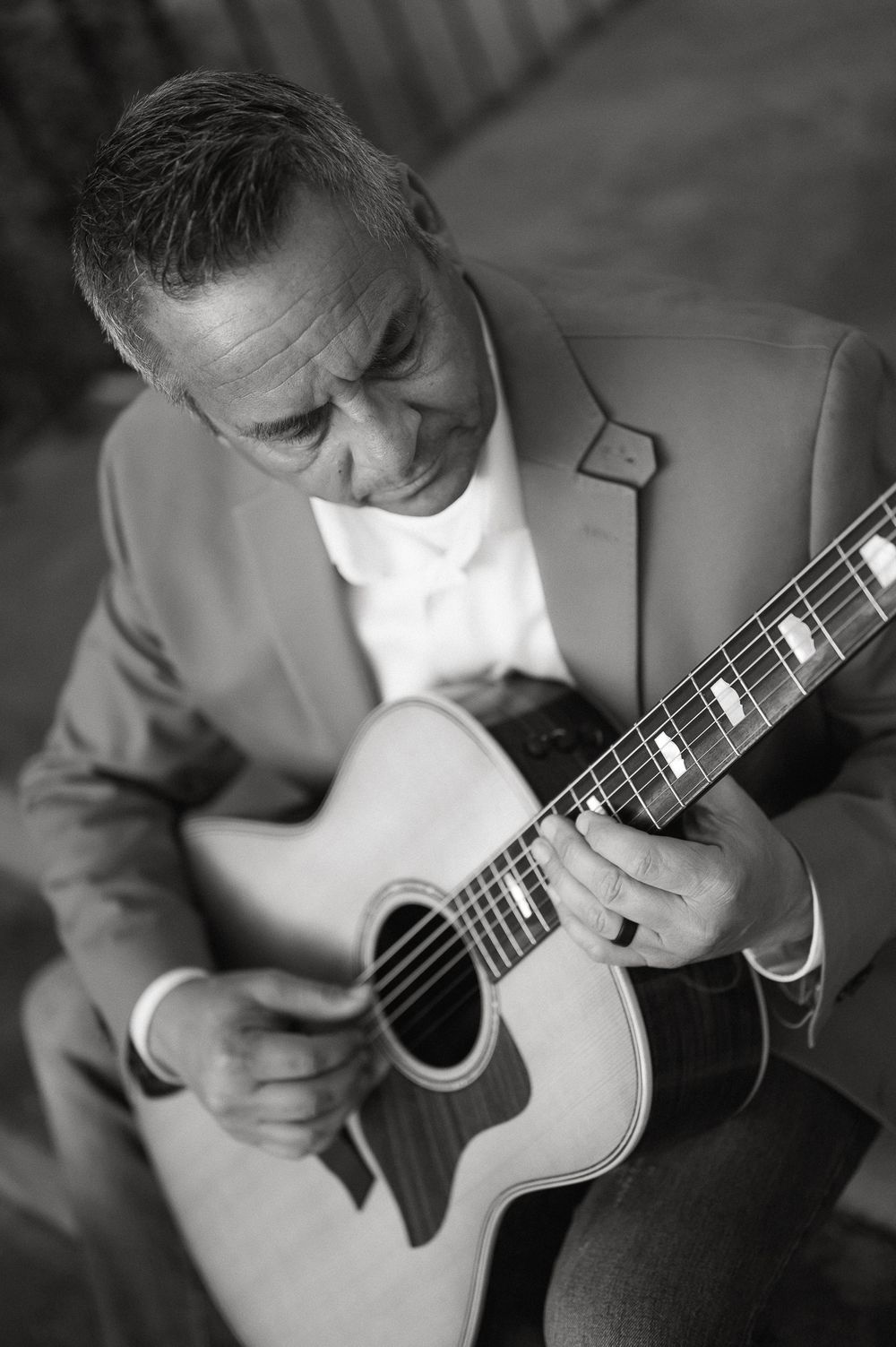 Brand photography by Tiffany Kelterer of San Diego of close up of man playing his guitar in Balboa Park