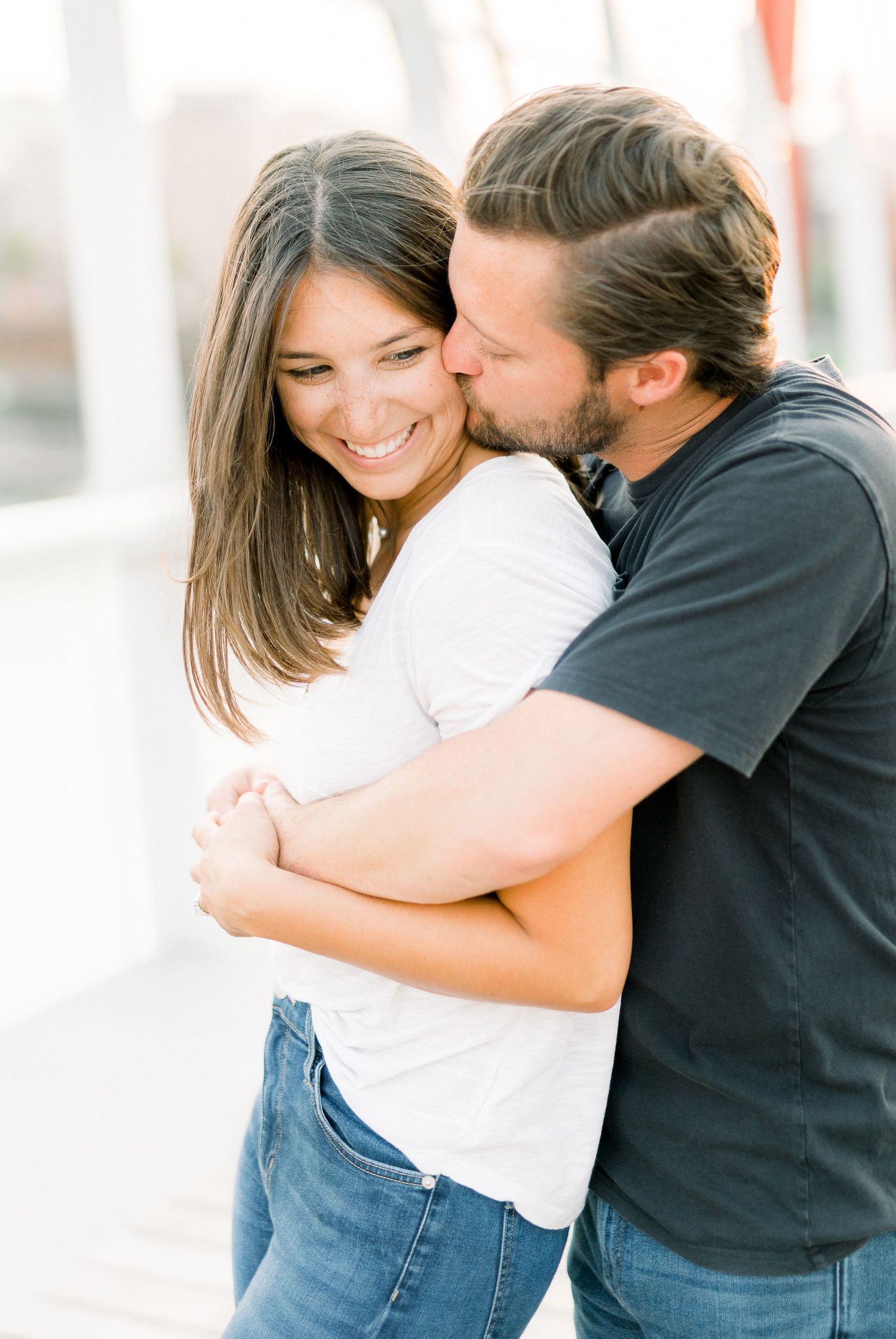 Des Moines Engagement photos in downtown Des Moines, Iowa with light and airy photographer Nicole Laing