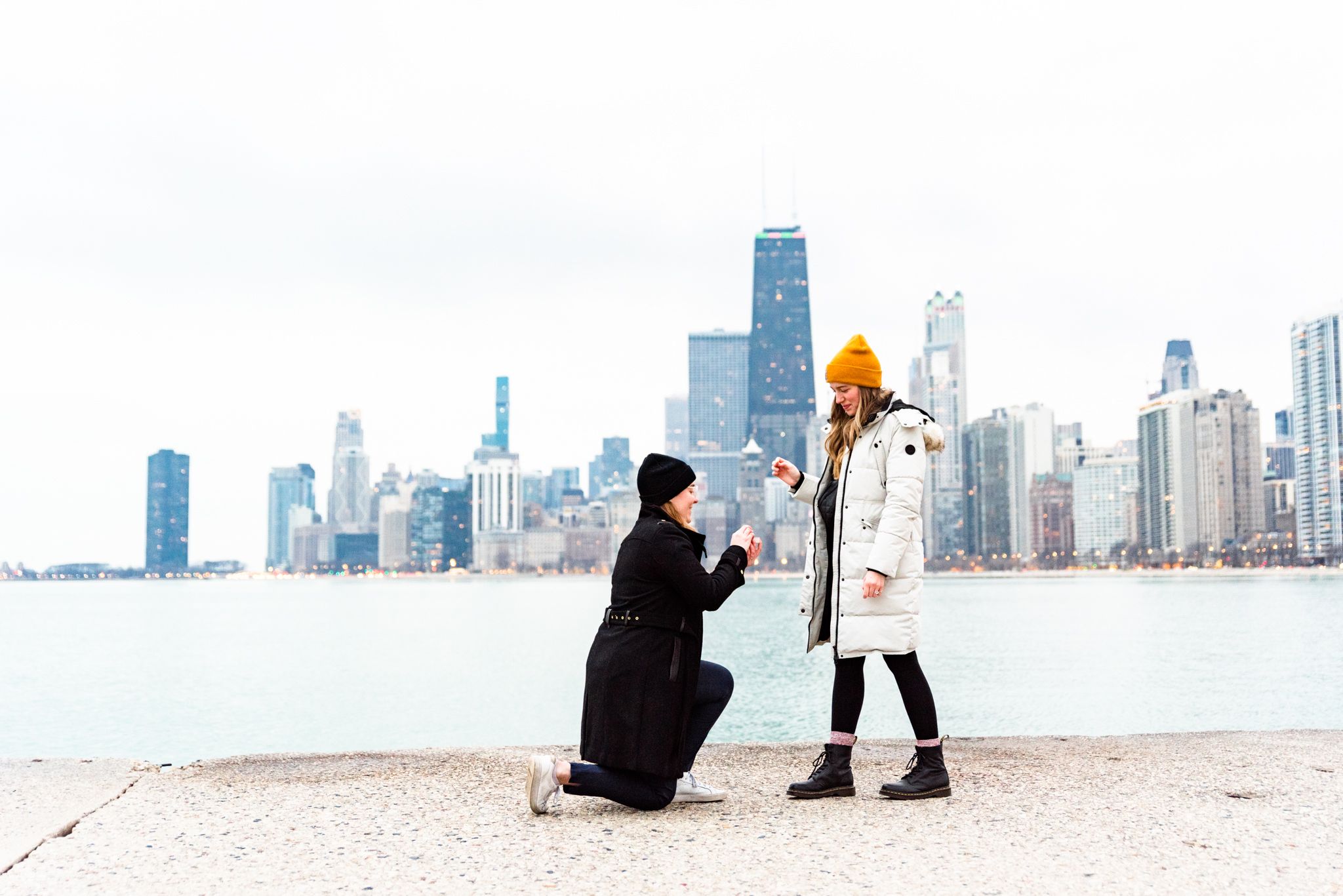 one woman on one knee proposing to girlfriend for Chicago proposal at North Avenue Beach