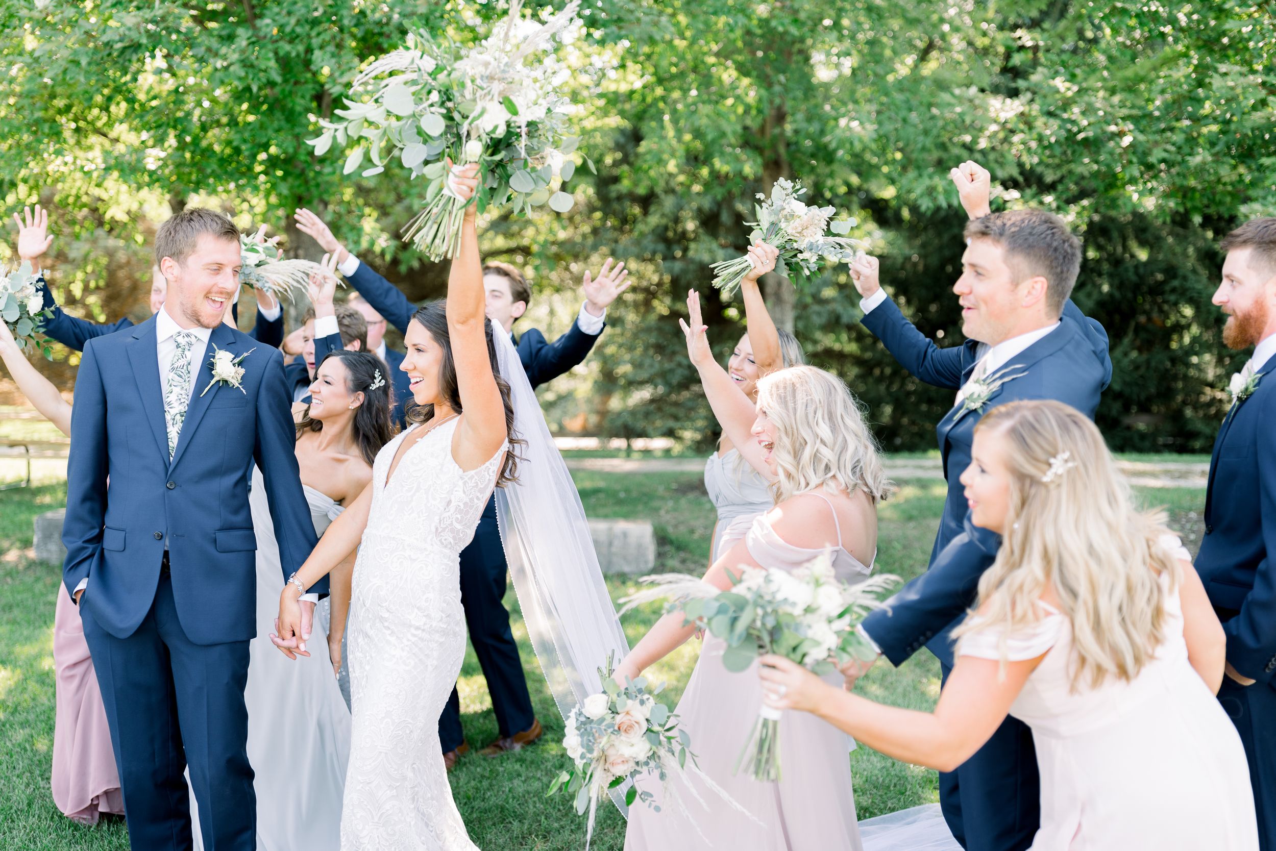 Vineyard bridal party photos with blue tuxes and pastel dresses at Prairie Moon Winery wedding in Ames, Iowa