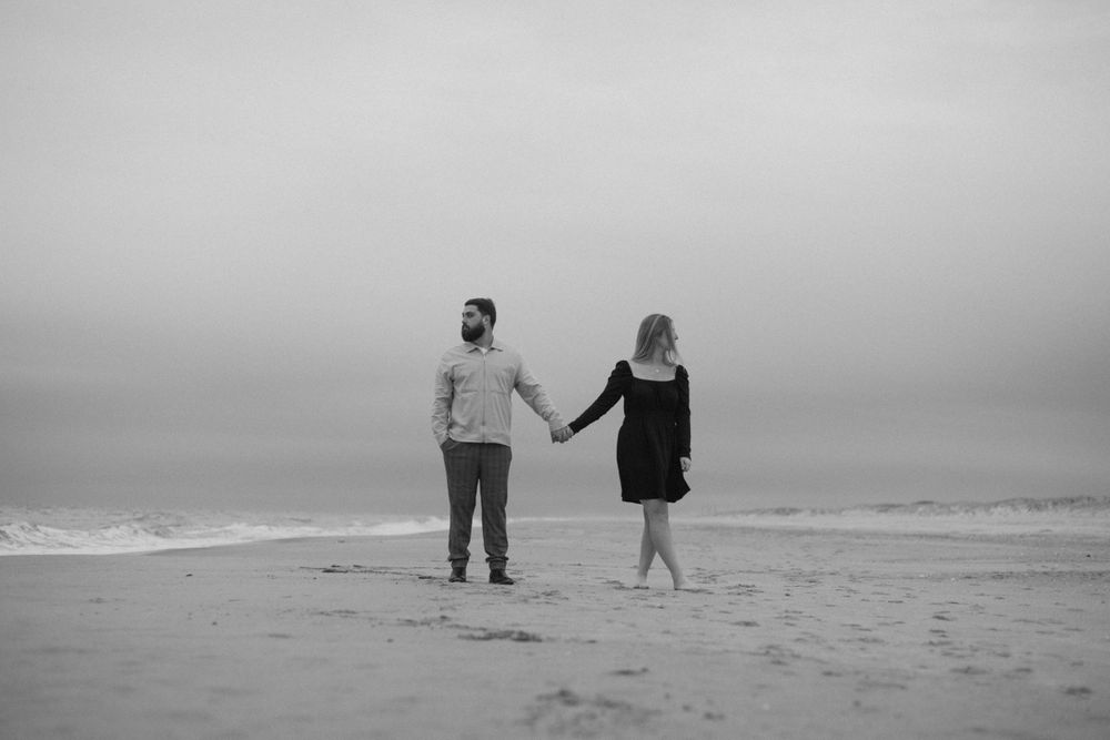 black and white filmy engagement picture on the beach