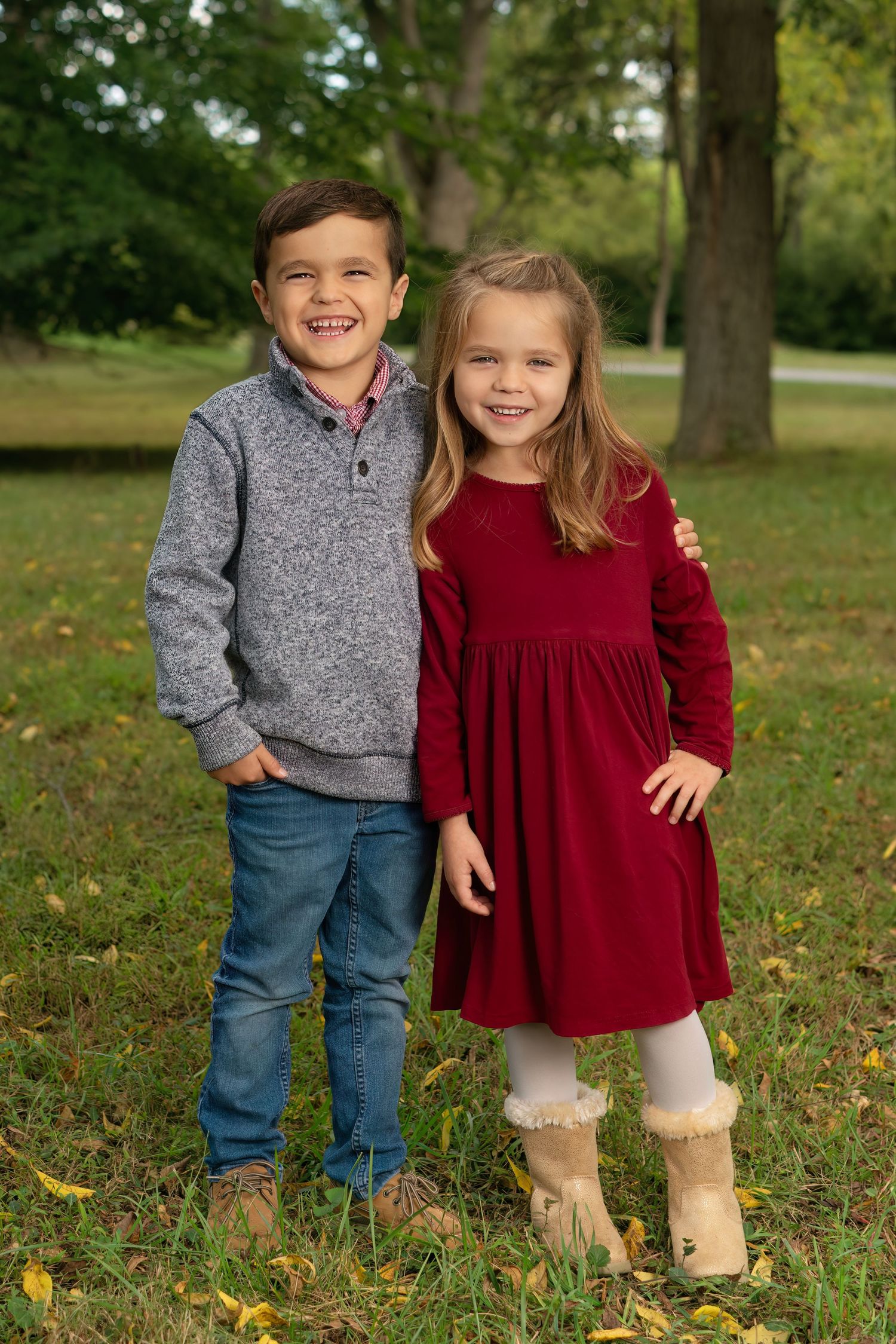 brother and sister giggle in outdoor sibling portrait