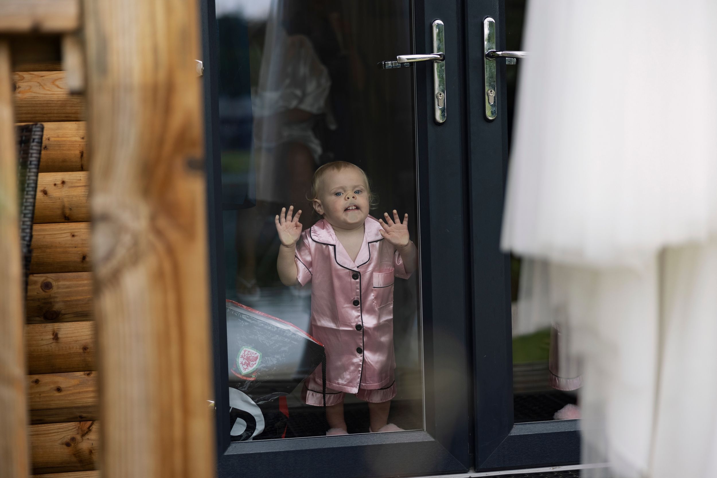 gorgeous flower girl pressed face against glass at Canada Lodge