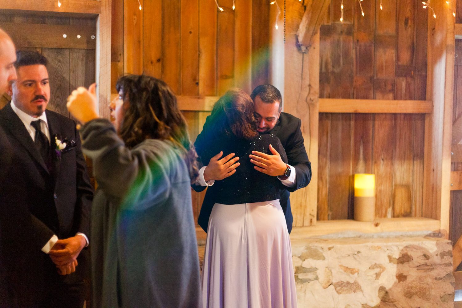 groom hugging his mother before wedding ceremony