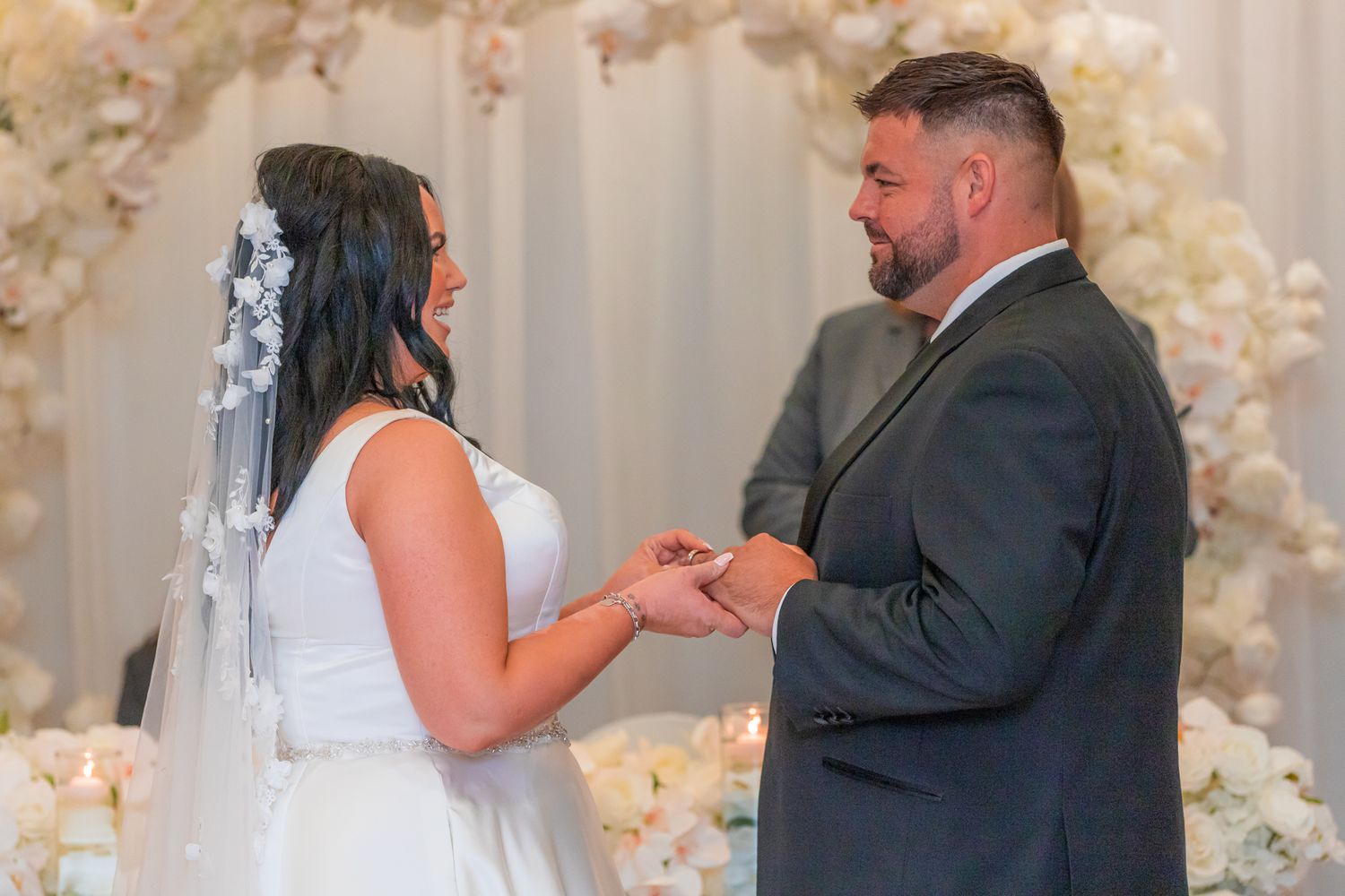 Wedding ceremony sequence showing couple at floral arch altar.