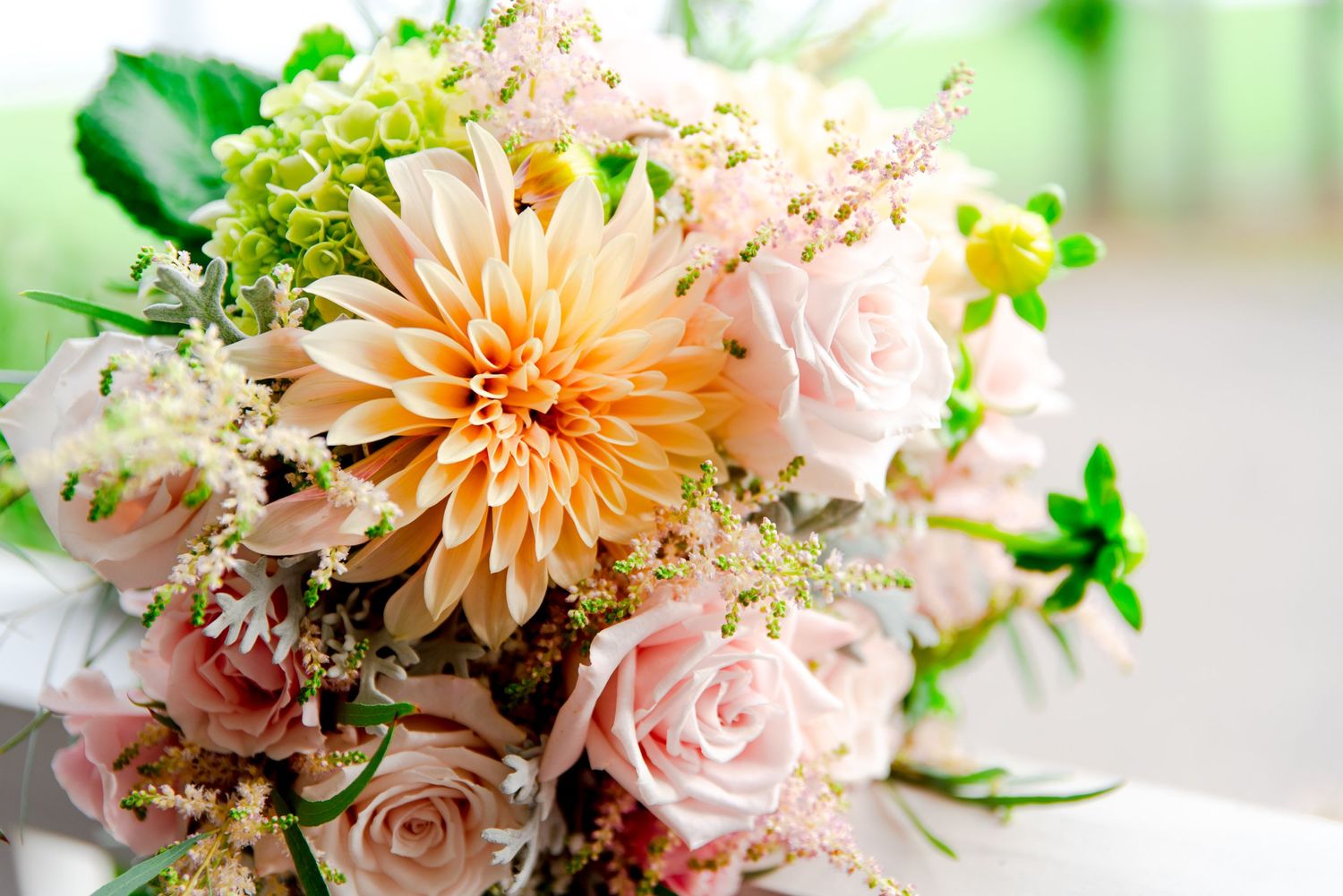 pastel yellow and pink spring wedding bouquet with dahlias and roses