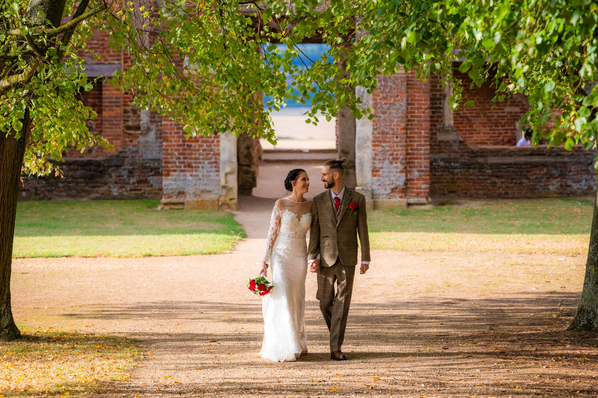 bride and groom walking holding hands, houghton house, Bedfordshire