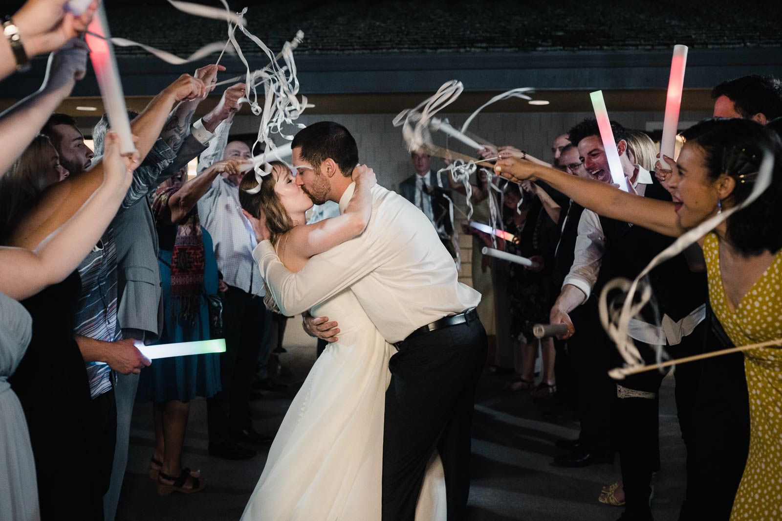 bride and groom kissing during the grand exit