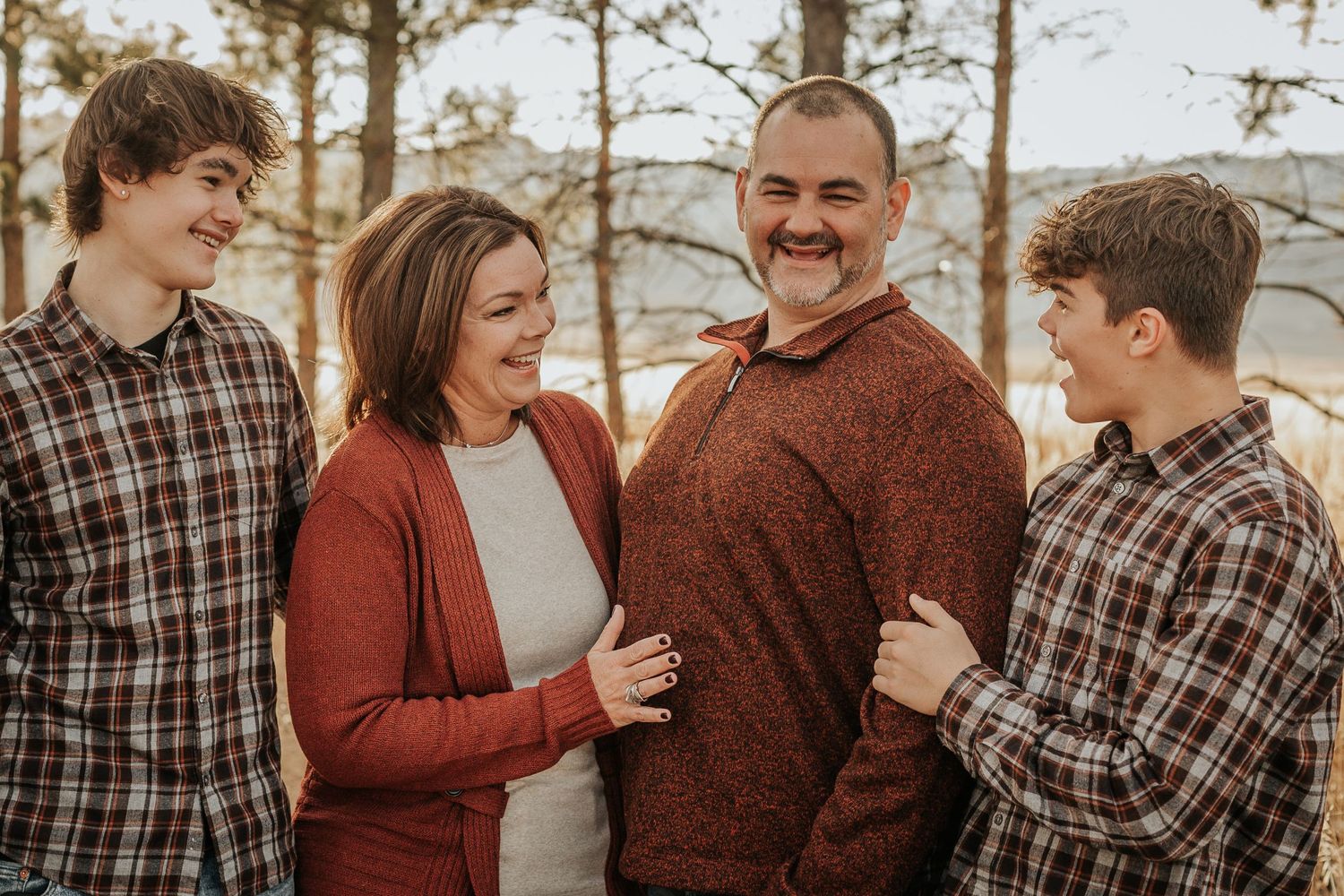 Family smiles at eachother during their Family Photography Session in Fort Collins, Colorado.