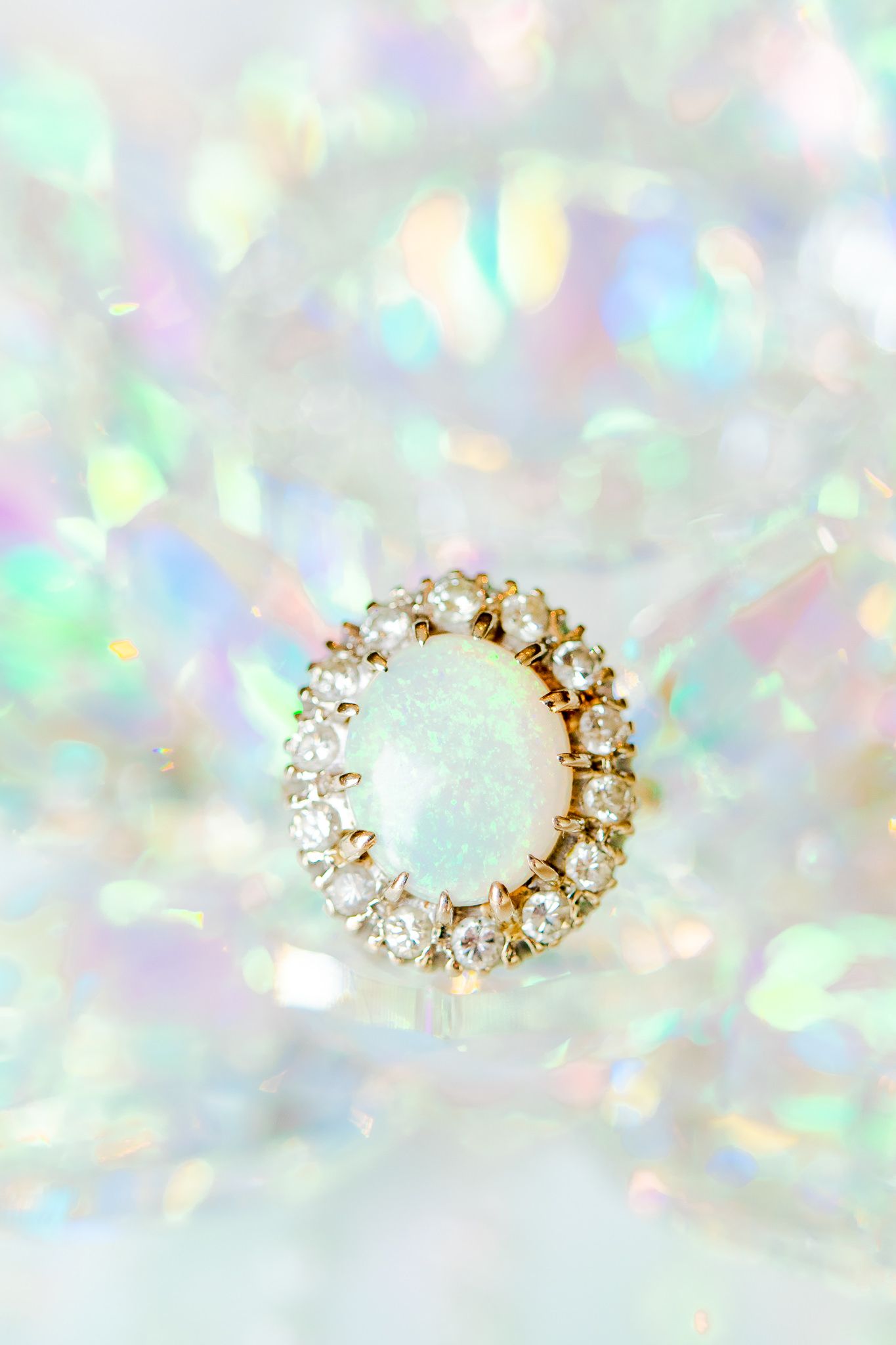 fire opal oval ring with iridescent rainbow background
