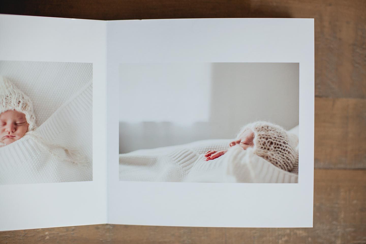 newborn photo album opened on a wood table