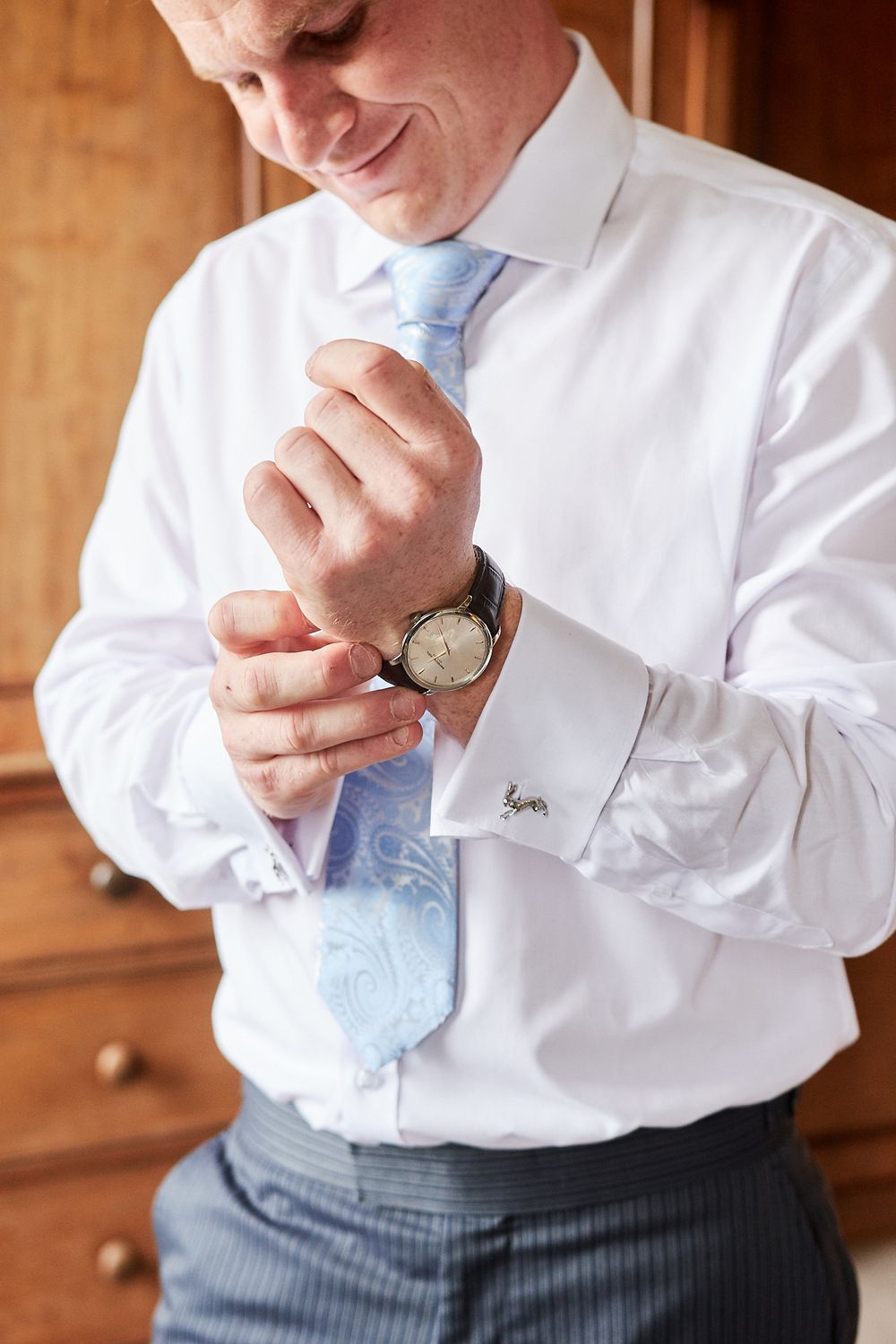 groom gets ready at Kimberly Hall, Norfolk. by Norwich wedding photographer Faye Amare