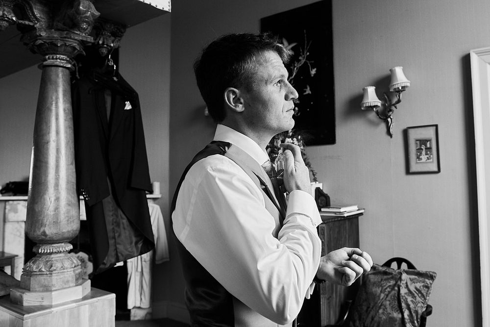 groom gets ready at Kimberly Hall Norwich, by Norwich wedding photographer Faye Amare