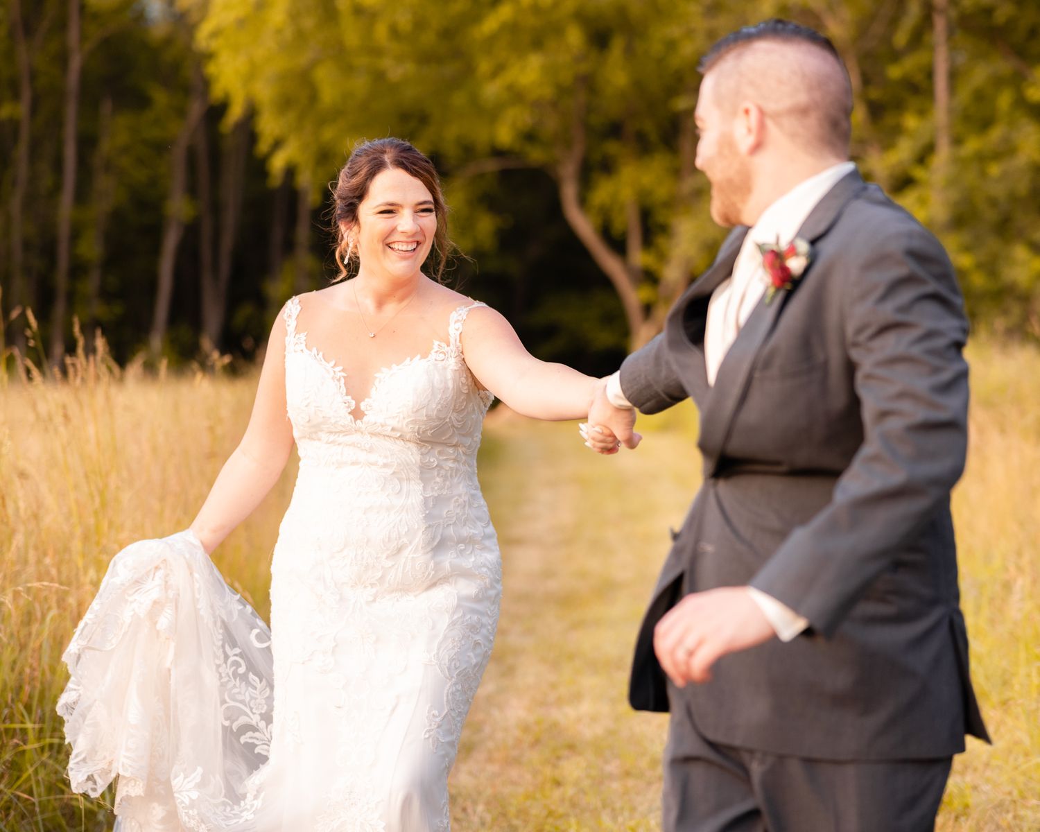 Bride and Groom Holding Hands and Running Through Tall Grass During Wedding at Magnolia Spring Farm in Magnolia, Ohio