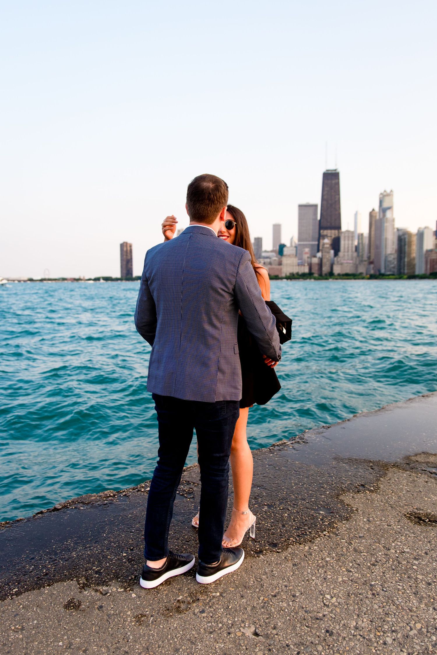 man going to hug woman after he proposed at North Avenue Beach pier