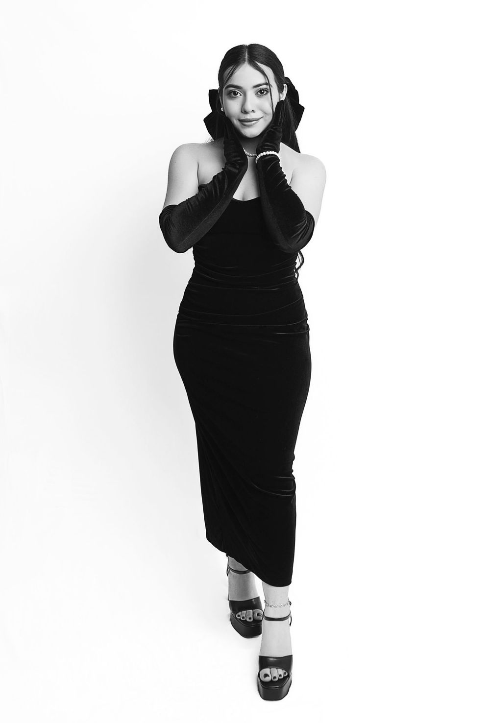 Black and white portrait featuring elegant velvet dress and long gloves.