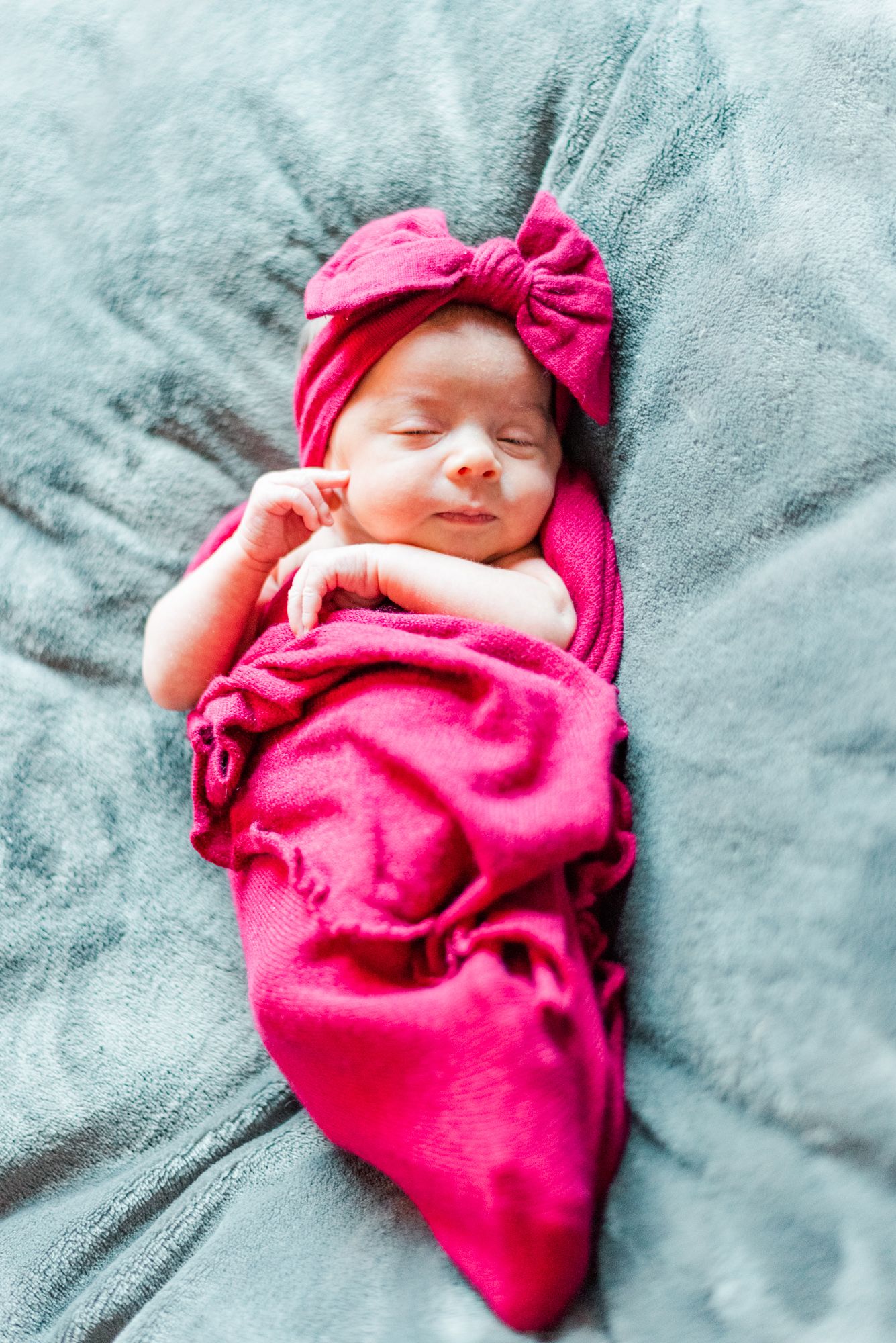 Lifestyle newborn baby in a pink wrap in Pittsburgh, Pennsylvania