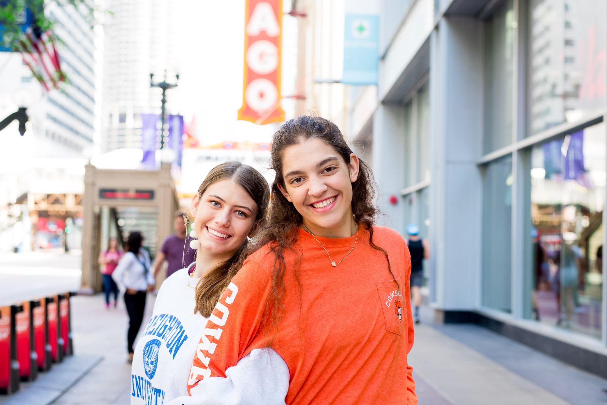 two senior girls in front of the Chicago Theater sign for Chicago senior pictures