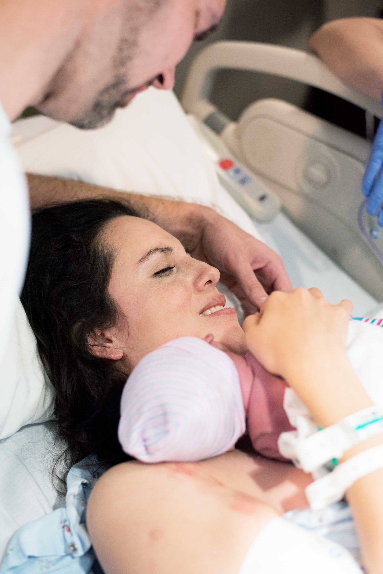 Mom holds newborn baby boy immediately after delivery