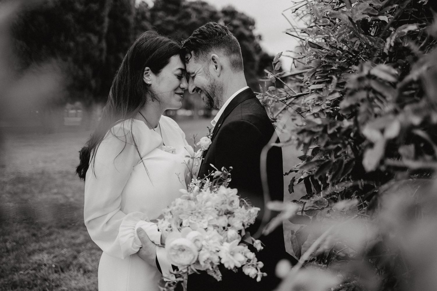 Intimate black and white moment captured among garden foliage.