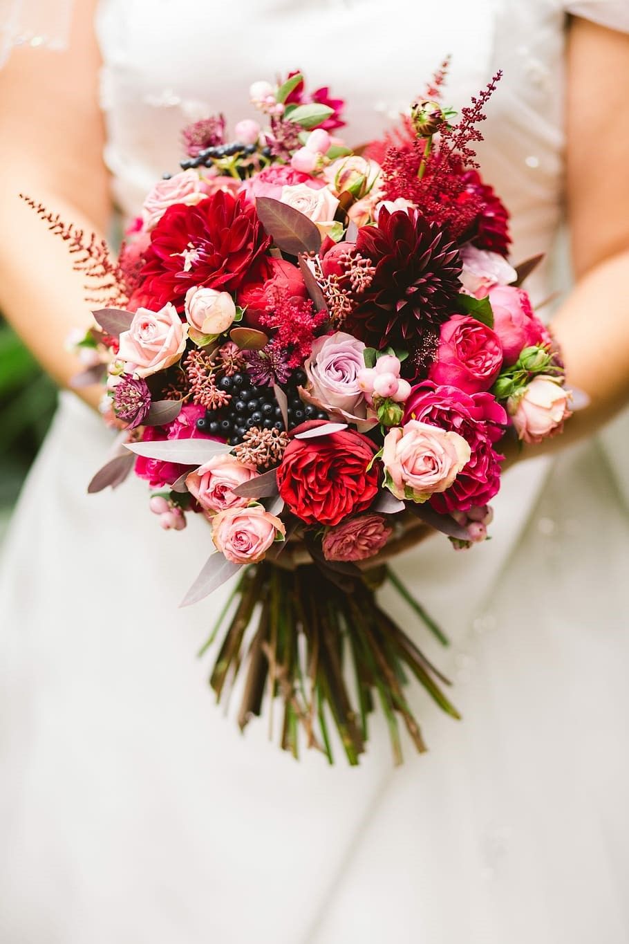 A woman holding wedding bouquet.