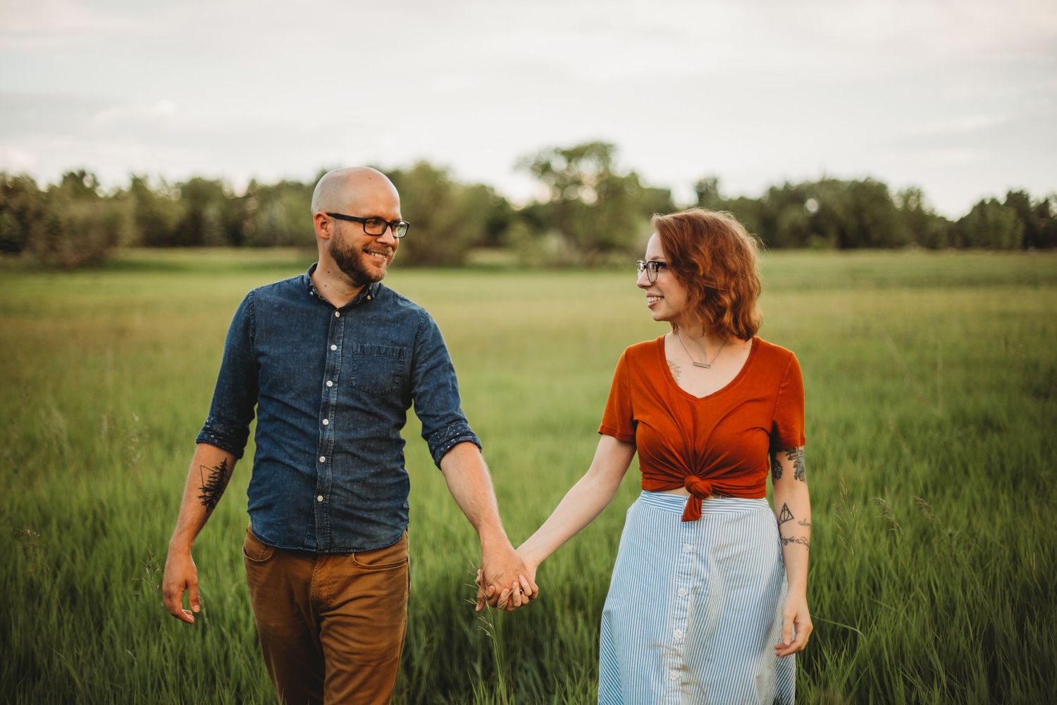 A couple walks along the path at Ross Natural Area during their portrait session in Fort Collins, Colorado.