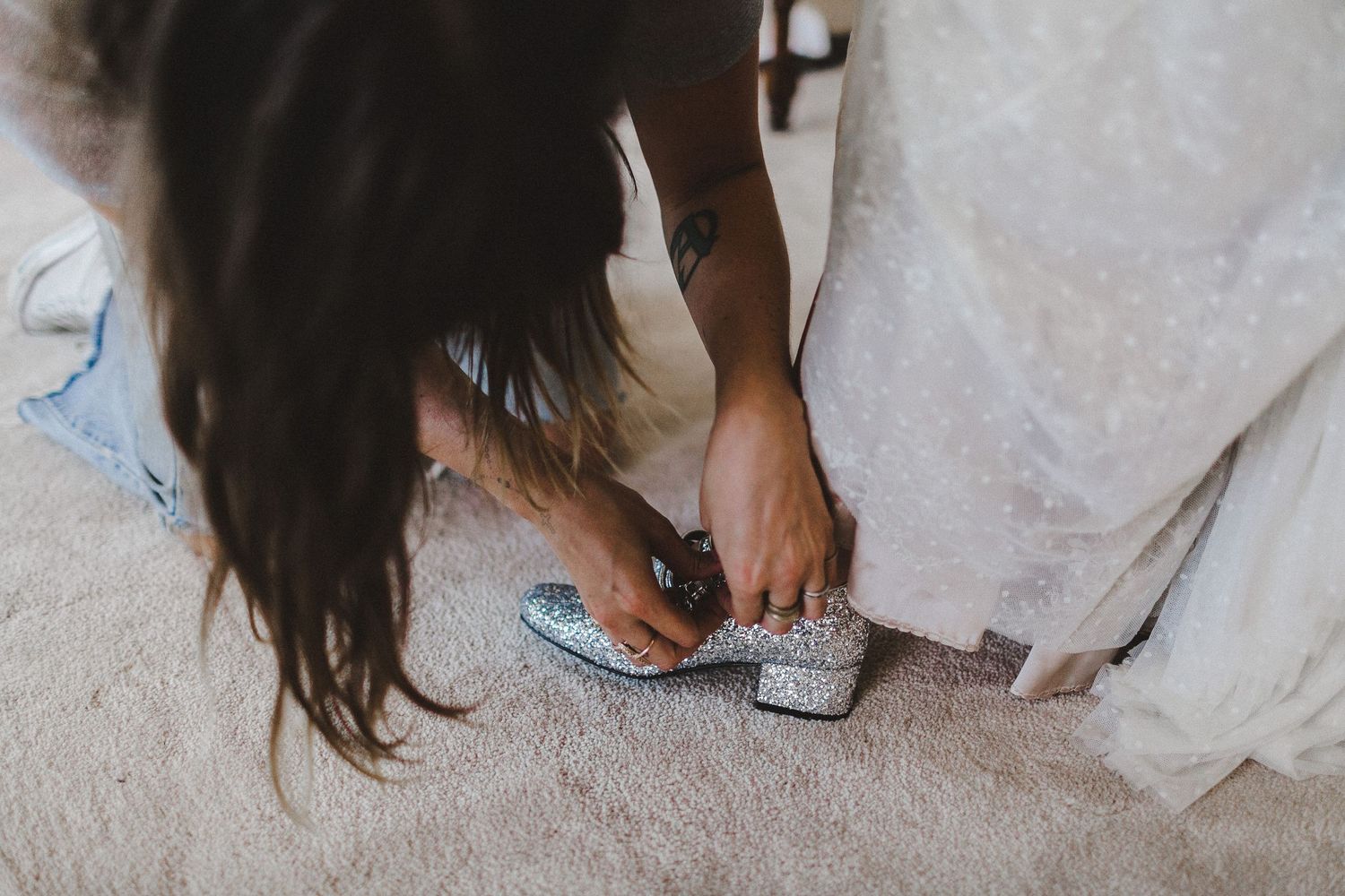 putting on shoes for bride